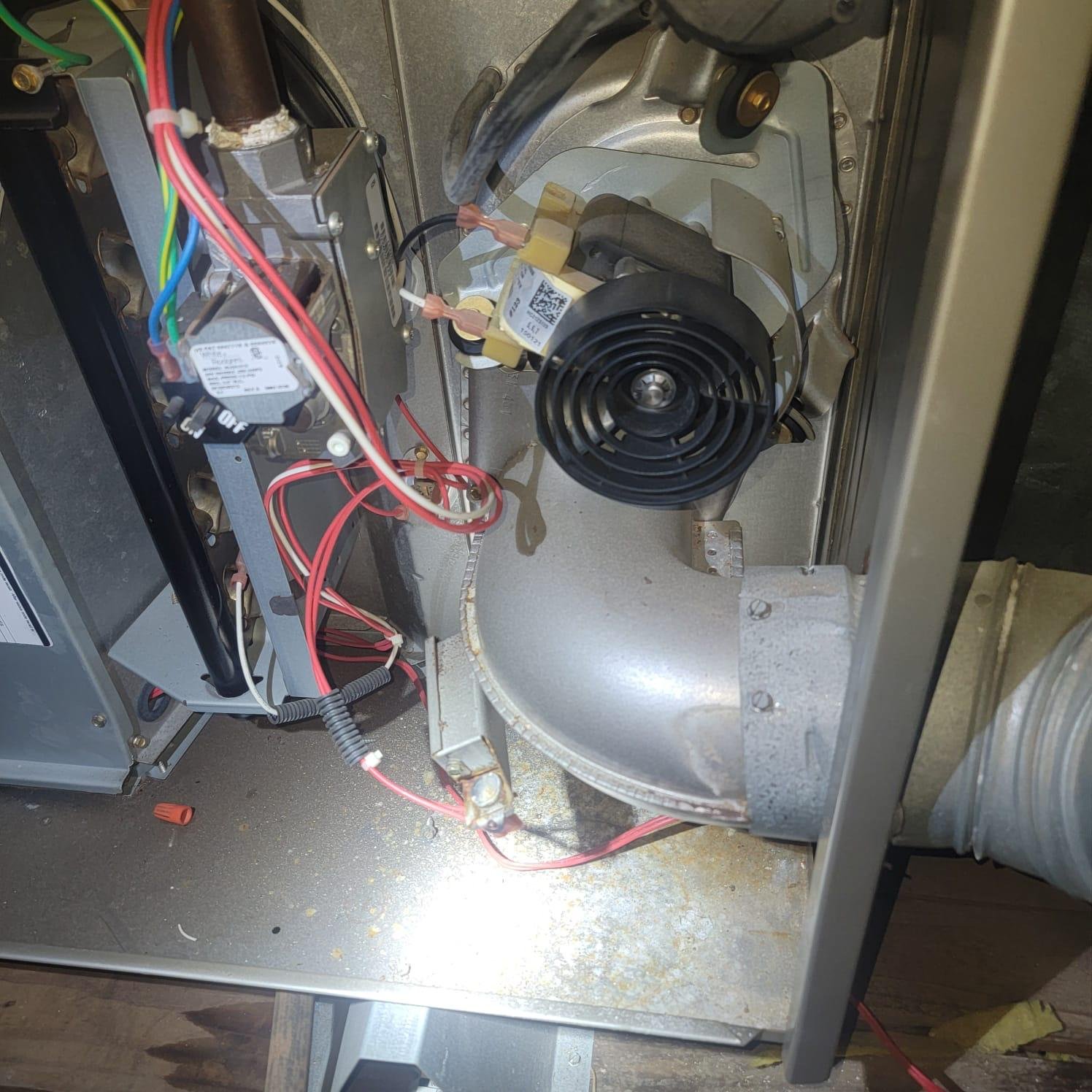 Professional HVAC technician repairing a furnace in Houston TX