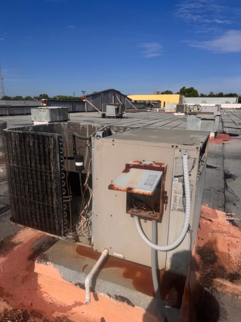 Houston HVAC technician repairing rooftop unit