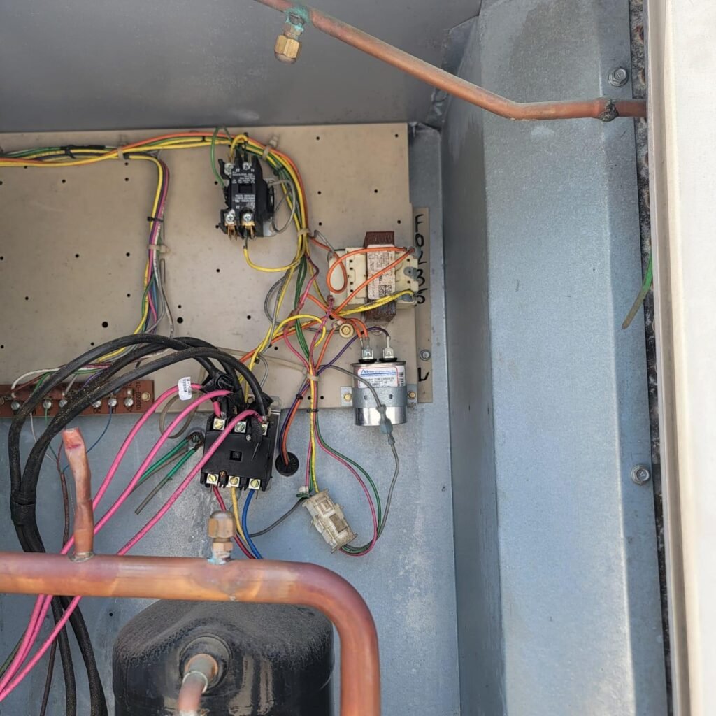 Experienced HVAC technician repairing an electrical panel in Houston TX